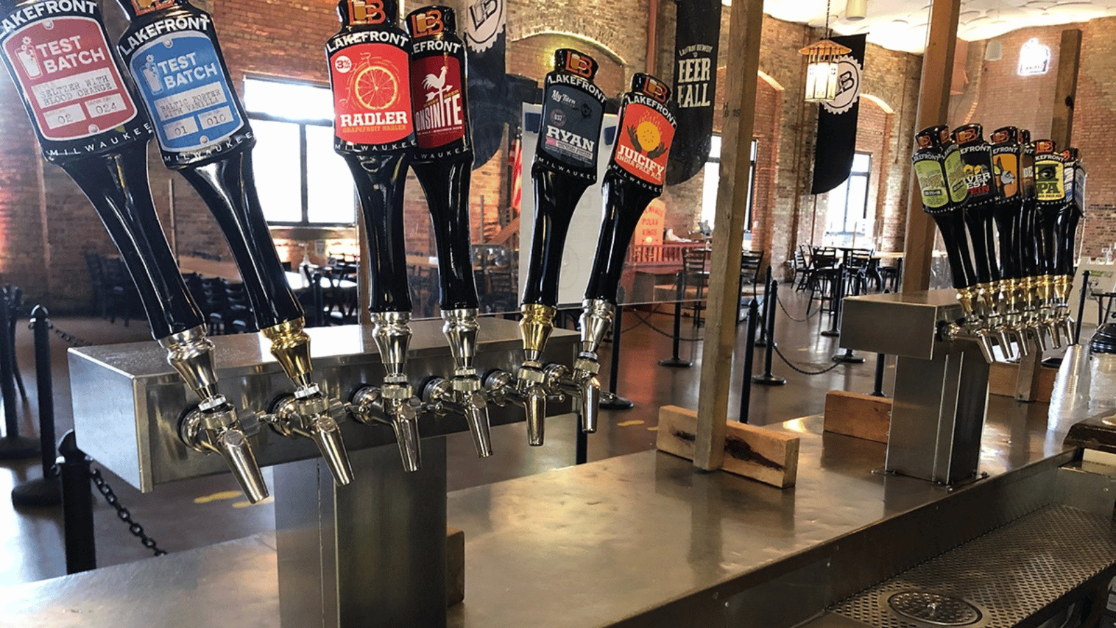 Row of Perlick taps for beer. Set of two sections, each with six taps for pouring beer.